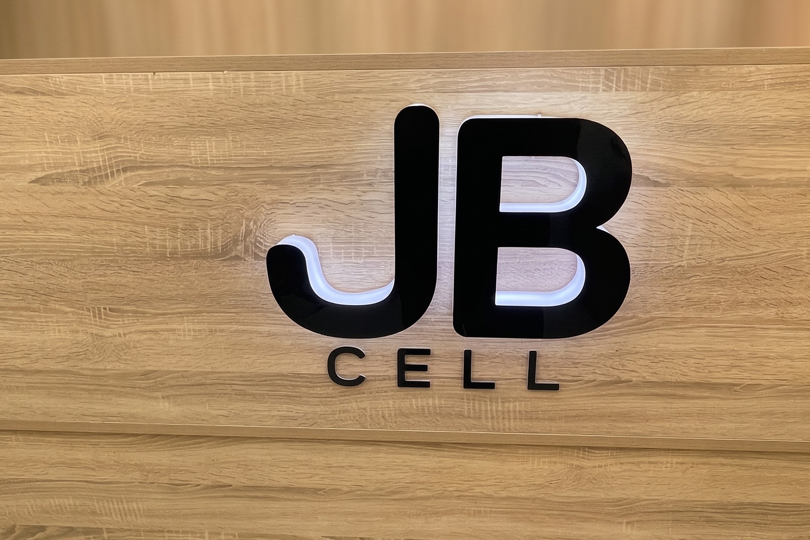 The JB Cell counter with the shop logo behind it